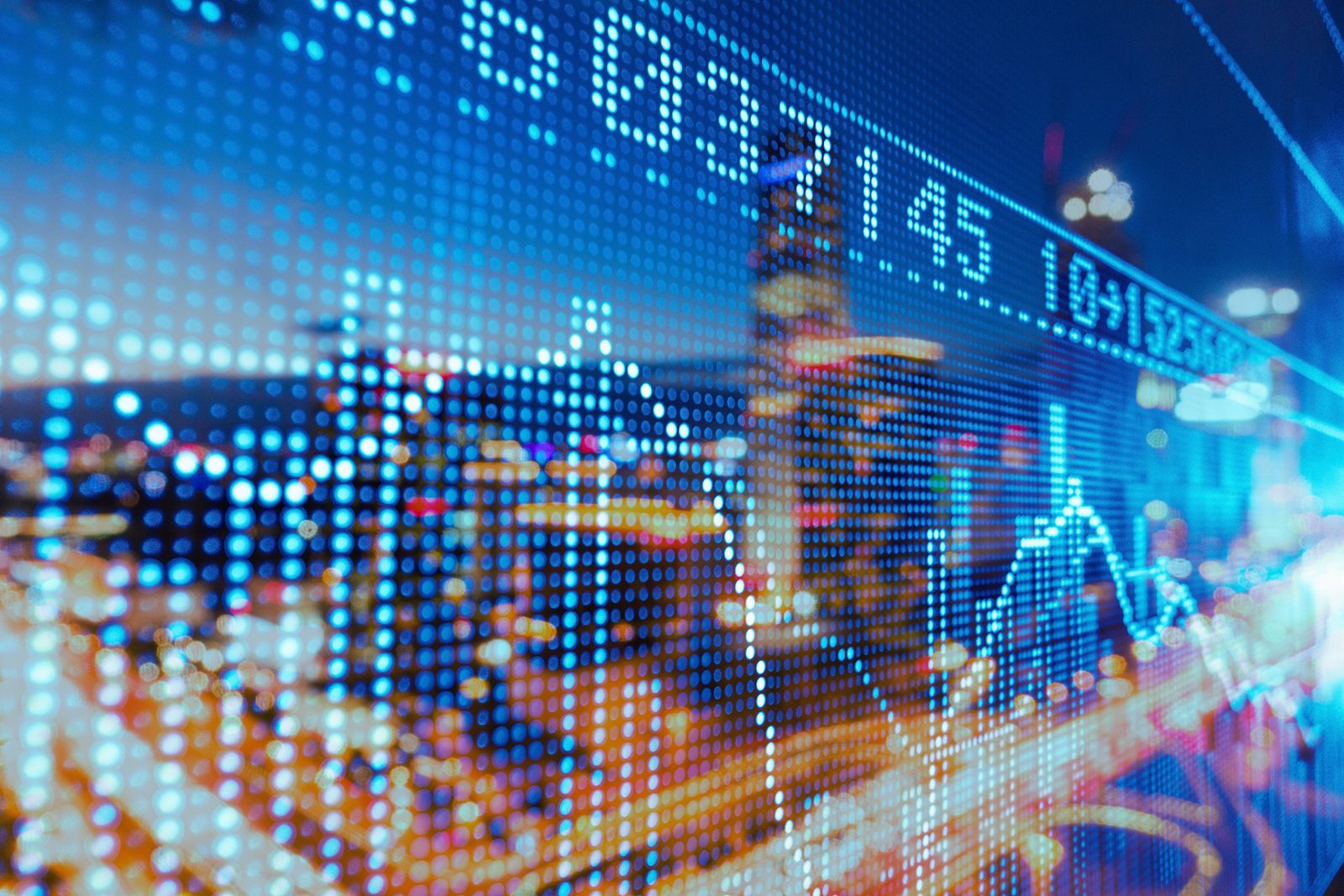 City skyline seen through a stock-market ticker